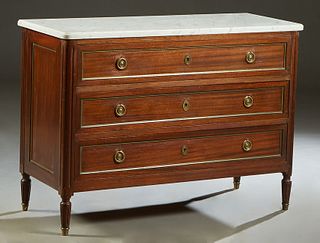 French Louis XVI Style Carved Mahogany Marble Top Commode, early 20th c., the rounded corner ogee edge figured white marble over three drawers, flanke