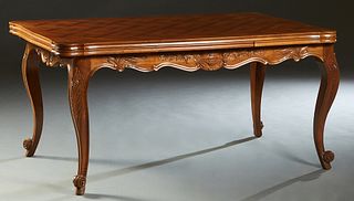 French Louis XV Style Carved Walnut Drawleaf Table, 20th c, the serpentine reeded parquetry inlaid top over a wide scalloped skirt, with two draw leav