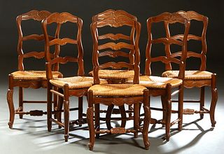 Set of Six French Provincial Louis XV Style Carved Walnut Dining Chairs, 20th c, the arched crestrail over a ladderback, to bowed rush seats on cabrio