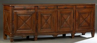 French Provincial Louis XIII Style Carved Oak Sideboard, 19th c., the stepped rounded corner and edge top over four frieze drawers above four fielded 