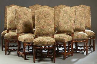 Set of Ten Louis XIII Style Carved Oak Dining Chairs, 19th c., the canted arched high upholstered backs over trapezoidal cushion seat, on cylindrical 