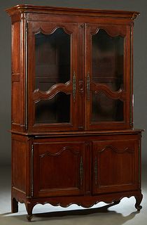 French Provincial Louis XV Style Carved Cherry Buffet a Deux Corps, 19th c., the stepped ogee rounded corner crown over two double glazed panel cupboa