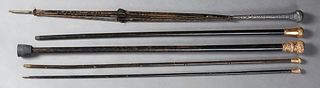 Group of Four Canes, late 19th c., and an umbrella frame, the four ebonized canes with gold filled ball handles; the umbrella with a weighted silverpl