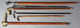 Group of Six Canes, 20th c., one with a heavy metal handle; a small riding crop with a metal horse's hoof handle; one ebonized with mother-of-pearl in