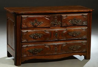 French Louis XIV Style Carved Walnut Commode, c. 1800, the serpentine top over three frieze drawers above two deep drawers, flanked by fielded panel s