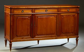 French Louis XVI Style Carved Cherry Sideboard, 20th c., the ogee edge cookie corner rectangular top over three frieze drawers above three fielded pan