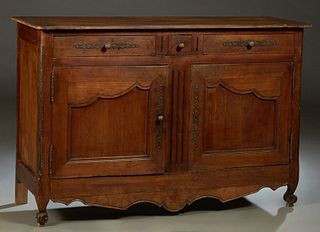 French Provincial Louis XV Style Carved Cherry Sideboard, 19th c., the rounded corner ogee edge rectangular top over three frieze drawers and double c