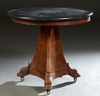 French Empire Carved Mahogany Marble Top Gueridon, 19th c., the dished circular figured black marble over a skirt on a tapered triangular support, on 