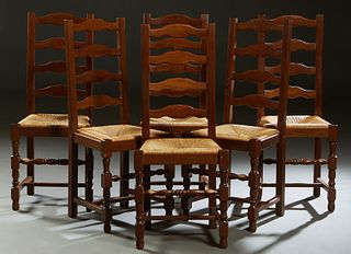 Set of Six French Provincial Carved Ladderback Rushseat Chairs, 20th c., the arched ladderback to a trapezoidal rush seat, on turned and square legs j