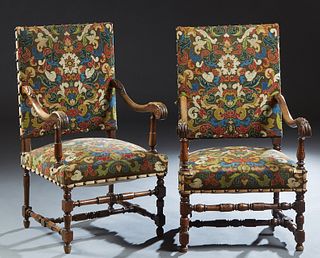 Pair of French Carved Mahogany Fauteuils a la Reine, early 20th c., the canted rectangular high backs over scroll carved arms on a cushioned seat, on 