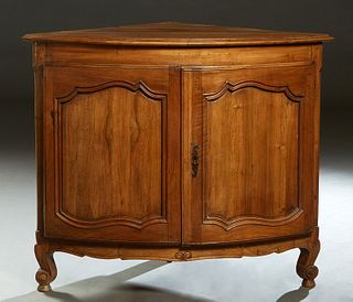 Large Louis XV Style Carved Walnut Corner Cabinet, late 19th c., the stepped curved top over double convex fielded panel cupboard doors, on a plinth b