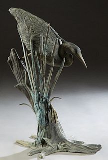 Patinated Bronze Garden Sculpture, 20th c., of a heron standing before cattails, on a branch from base, H.- 36 in., W.- 24 in., D.- 21 in. Provenance: