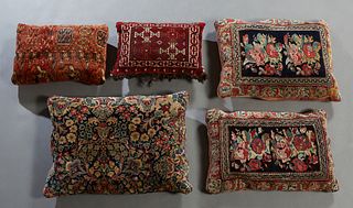 Group of Five Oriental Carpet Pillows, 20th c., two with floral designs and roped edges, one in brocade design, one with orange background, and one wi