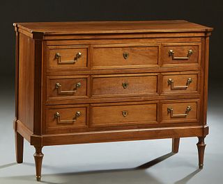 French Louis XVI Style Carved Walnut Commode, early 20th c., the canted corner rectangular top over three setback deep drawers, flanked by canted reed