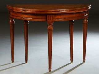 French Louis XVI Style Carved Cherry Demilune Games Table, 20th c., the ogee edge top over a wide skirt, on turned tapered reeded legs with ormolu sab
