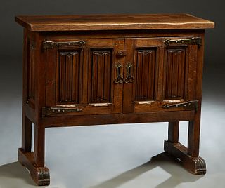 Spanish Renaissance Style Carved Oak Sideboard, early 20th c., the rectangular top over double linen fold carved cupboard doors with iron strap hinges