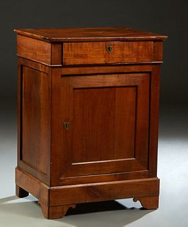 French Louis Philippe Carved Cherry Confiturier, 19th c., the rectangular top over a frieze drawer and a setback cupboard door, on a plinth base on br