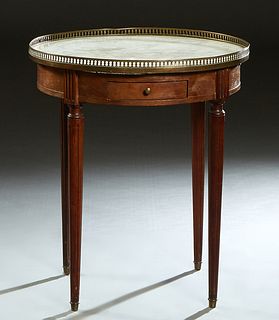 French Louis XVI Style Marble Top Lamp Table, early 20th c., the brass galleried circular figured white marble, over two small frieze drawers, on turn