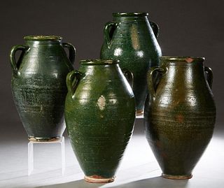 Group of Four French Provincial Green Glazed Pottery Baluster Oil Jars, late 19th c, each with applied double ring handles, Largest- H.- 17 1/2 in., D