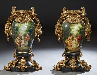 Pair of Polychromed and Gilt Composite Baluster Urns, 20th c., painted with reserves over lovers in a garden on a integral rounded star form base, H.-