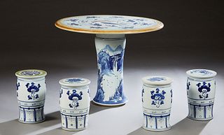 Chinese Porcelain Five Piece Patio Set, 20th c., consisting of a circular table with fish decoration and four blue and white cylindrical stools, H.- 2