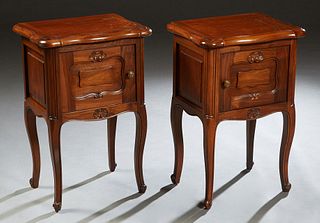Pair of Louis XV Style Carved Walnut Bowfront Nightstands, 20th c., the serpentine ogee edge top over a fielded panel cupboard door on scrolled cabrio