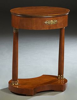 Ormolu Mounted Carved Mahogany Oval Lamp Table, 20th c., the banded top on two ormolu mounted tapered columns, on a convex carved base, H.- 26 in ., W