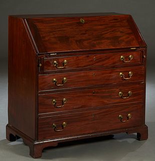 English Georgian Style Carved Mahogany Slant Front Desk, 19th c., the rectangular top over the slant lid, opening to an interior fitted with seven dra