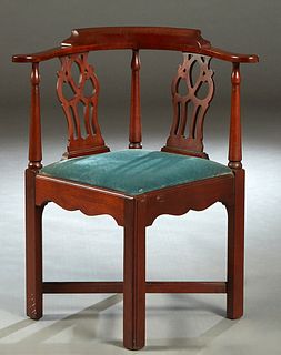 English Carved Mahogany Chippendale Style Corner Chair, 19th c., the curved back with two pierced splats, over a slip seat, on square legs joined by a