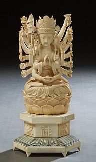 Large Oriental Carved Bone Figure, early 20th c., of a Shiva with 14 arms, seated on a lotus decorated cushion, on a stepped hexagonal plinth, to an o