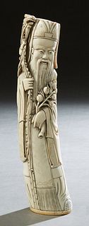 Chinese Carved Bone Figure of a Sage, early 20th c., with scrimshaw decoration, signed on the underside, H.- 12 in., W.- 2 5/8 in., D.- 2 1/4 in. Prov