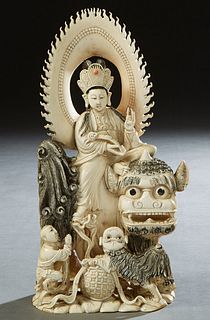 Chinese Carved Bone Seated Kwan Yin Figure, early 20th c., with a pierced corona, and scrimshaw decoration, with an octopus and a child on her right a