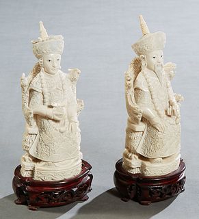 Pair of Chinese Carved Bone Seated Emperor and Empress Figures, early 20th c., with a signature on the underside, on carved mahogany stands, H.- 7 1/4