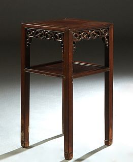 Chinese Carved Mahogany Two Tier Lamp Table, 20th c., the square top over a pierced skirt, above a lower shelf, on square legs with spade feet, H.- 31