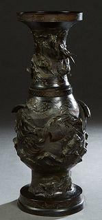 Large Japanese Patinated Bronze Baluster Vase, early 20th c., the everted Greek key decorated rim over a relief dragon figure, above a lower relief se