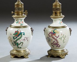 Pair of Bronze Mounted Chinese Crackleware Porcelain Lamps, late 19th c., originally fitted as oil lamps, with baluster bodies, on circular relief bro