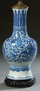Chinese Ming Style Porcelain Baluster Urn, 19th c., with blue and white floral decoration, now on a carved mahogany base wired as a lamp, H.- 17 in., 