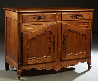French Provincial Louis XV Style Carved Cherry Sideboard, 19th c., the rounded corner and edge top over two frieze drawers with steel escutcheons, abo