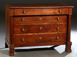 French Empire Carved Walnut Commode, 19th c., the rectangular top over a frieze drawer and three setback deep drawers, flanked by turned columns, on a