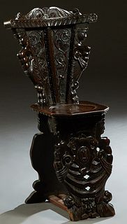 Continental Carved Mahogany Hall Chair, 19th c., the arched scrolled crest over tapered figural carved back to an octagonal seat, on figural carved su