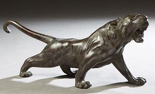 Japanese Meiji Patinated Bronze Stalking Tiger, with an attached  calligraphy label on the underside, H.- 9 in., W.- 19 1/4 in., D- 5 in. Provenance: 