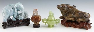 Group of Four Chinese Carved Jade Pieces, 20th c., consisting of a green jade covered censer; a mottled brown covered censer; a resting dark green Ox 