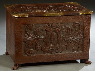 English Brass Mounted Carved Oak Coffer, 19th c., the leaf carved lid with wide brass corners, over a like carved front panel, on paw feet, H.- 20 3/4