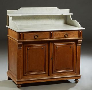 French Louis Philippe Style Oak Marble Top Washstand, early 20th c., the figured shelved and bracketed white marble on a base with two frieze drawers 