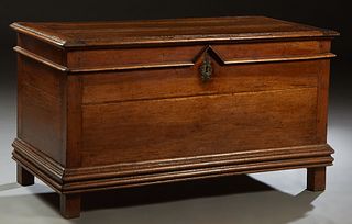 French Carved Walnut Coffer, 19th c., the stepped edge rectangular top over a front panel with applied geometric decoration, on a stepped plinth base 