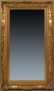 French Louis XV Style Gilt and Gesso Overmantel Mirror, 20th c., with a wide relief decorated figure with pierced scrolled edges, around a wide bevele
