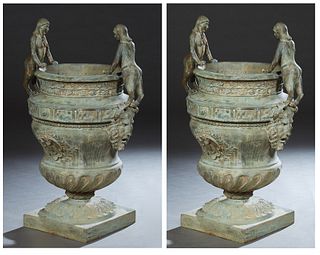Pair of Large Iron Campana Form Garden Urns, 20th c., the everted relief rim over figural relief sides, above reeded socle supports to a square base o
