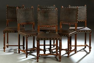 Set of Six French Henri II Style Carved Walnut Dining Chairs, c. 1880, with initial embossed brown leather backs, over leaf embossed brown leather sea