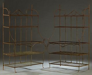 Pair of Wrought Iron Bakers Racks, 20th/21st c., each with four shelves, on scrolled supports, H.- 72 in., W.- 44 in., D.- 24 in.