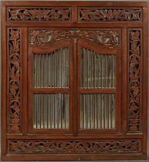 Oriental Carved Mahogany Window Frame, 20th c., with double arched ribbed center doors, now backed by a mirror, flanked on all sides with pierced leaf